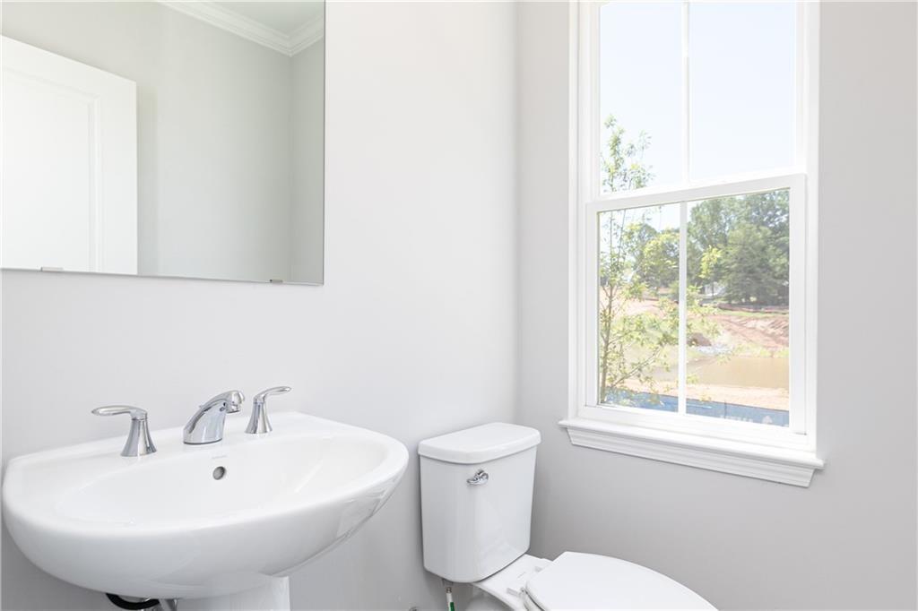 1009 Taylor Court Acworth, GA 30102 - Photo 17 of 30 a bathroom with a sink a toilet and a mirror