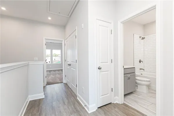 a bathroom view of a toilet and a hardwood