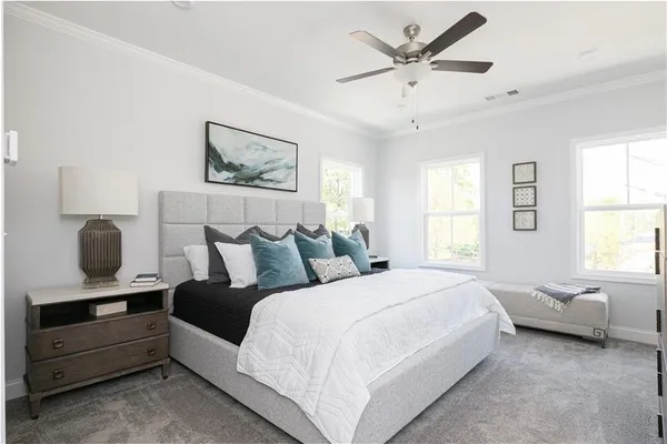 a bedroom with a bed and a window