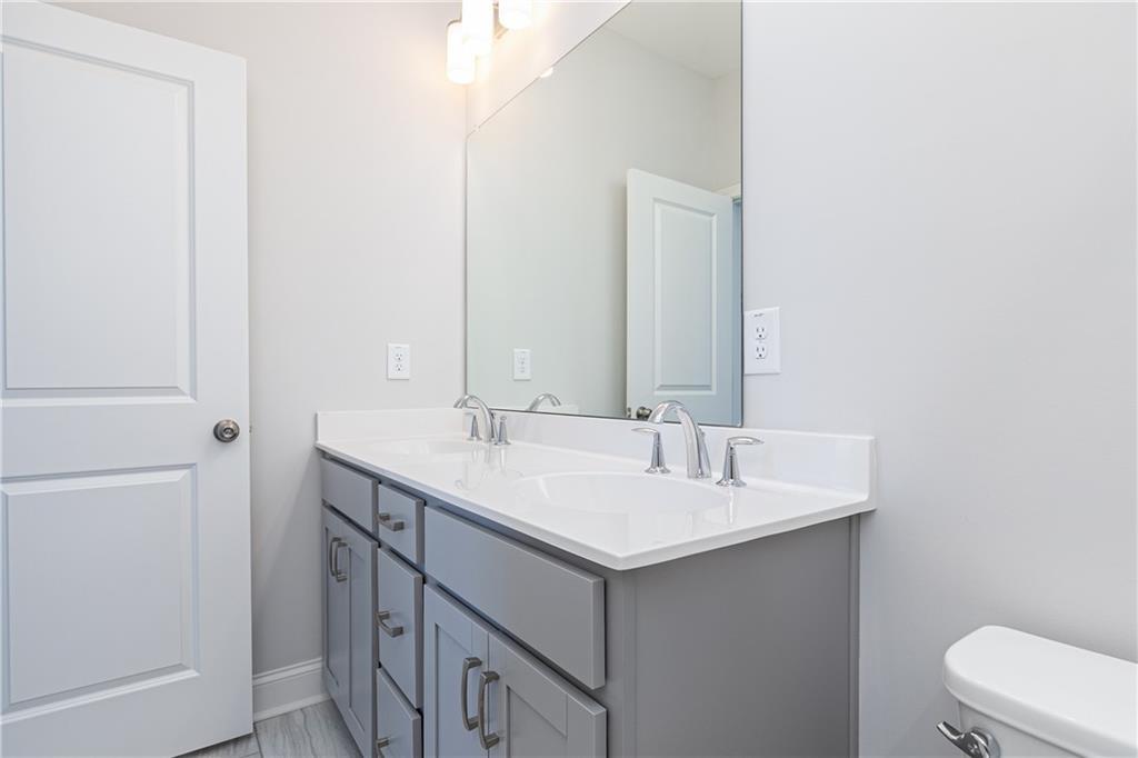 1009 Taylor Court Acworth, GA 30102 - Photo 22 of 30 a bathroom with a sink and a mirror