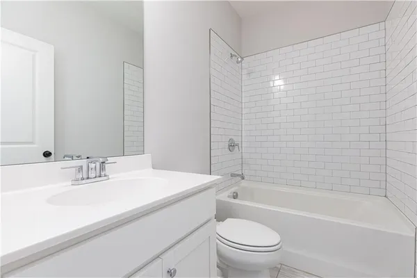 a bathroom with a sink a toilet and bathtub