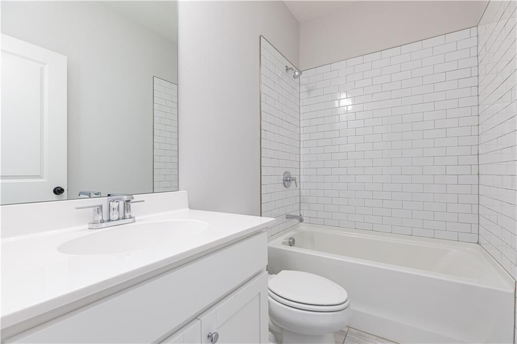 1009 Taylor Court Acworth, GA 30102 - Photo 26 of 30 a bathroom with a sink a toilet and bathtub