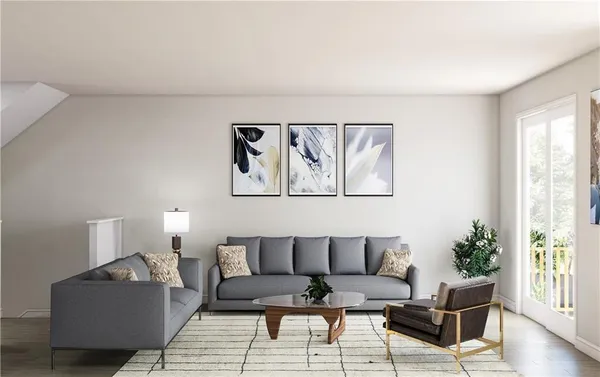 a living room with furniture and a painting on the wall