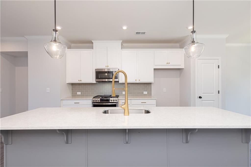 1009 Taylor Court Acworth, GA 30102 - Photo 7 of 30 a kitchen that has a lot of cabinets and wooden floor