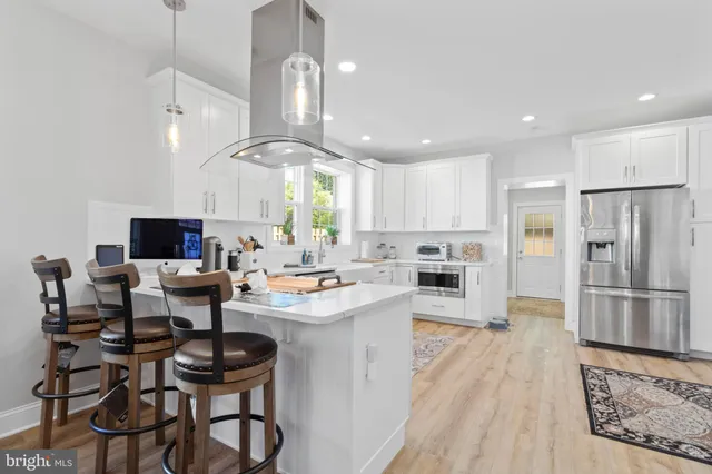a kitchen with stainless steel appliances kitchen island granite countertop a sink and cabinets