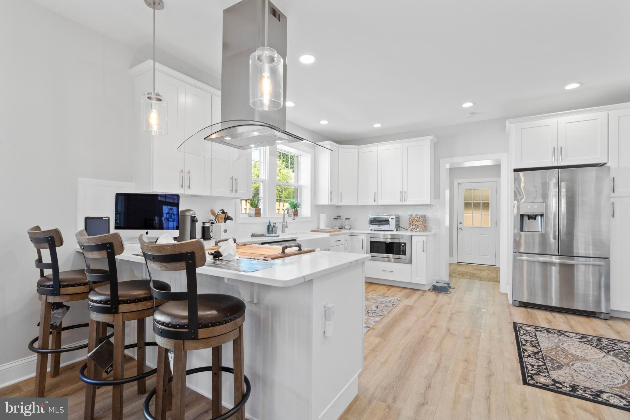 528 Lower E Valley Forge Road King of Prussia, PA 19406 - Photo 11 of 40 a kitchen with stainless steel appliances kitchen island granite countertop a sink and cabinets