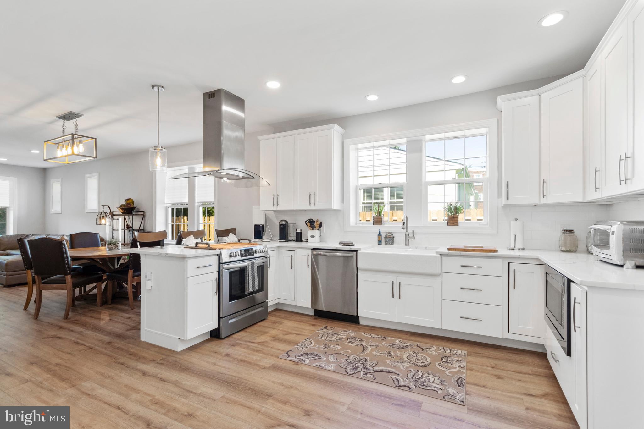 528 Lower E Valley Forge Road King of Prussia, PA 19406 - Photo 12 of 40 a kitchen with a white cabinets and wooden floor