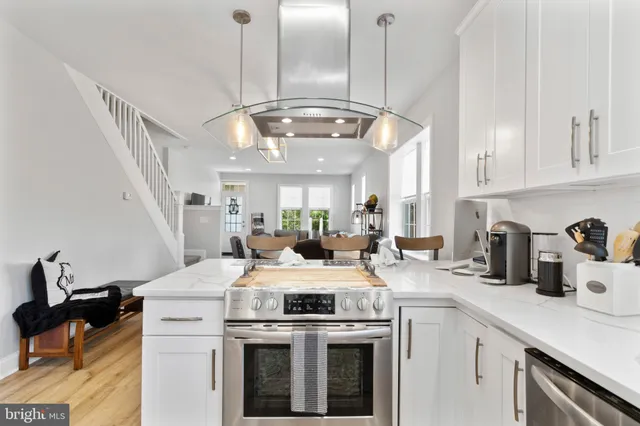 a kitchen with a stove kitchen island and stainless steel appliances