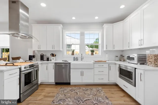 a kitchen with a stove top oven sink and cabinets
