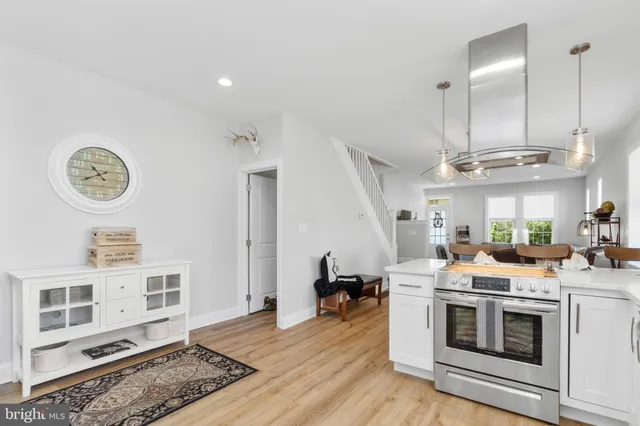a open kitchen with a stove a sink and a refrigerator