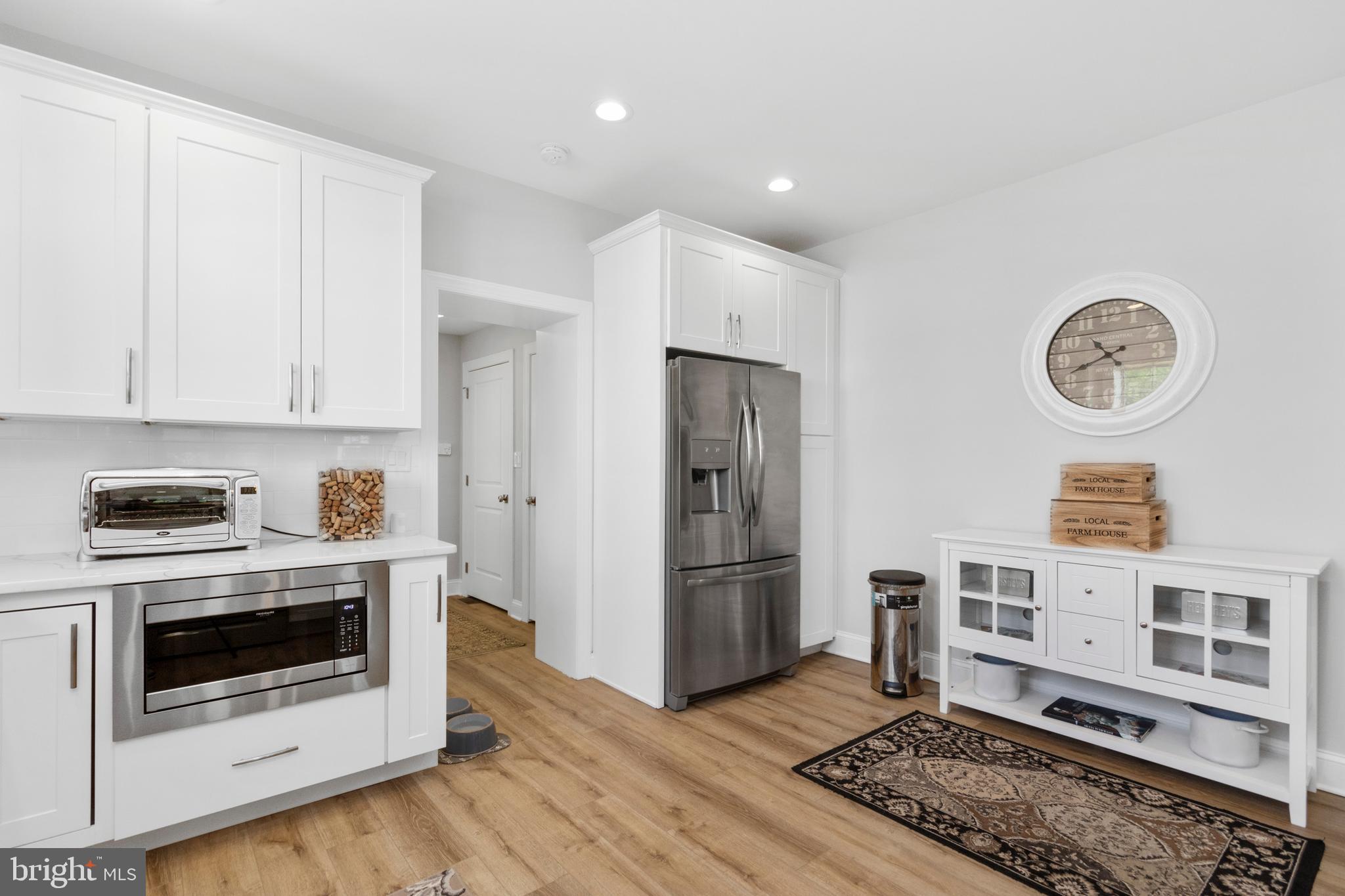 528 Lower E Valley Forge Road King of Prussia, PA 19406 - Photo 16 of 40 a kitchen with stainless steel appliances granite countertop a stove a refrigerator and a microwave