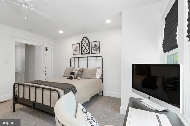 a bedroom with a bed and a television