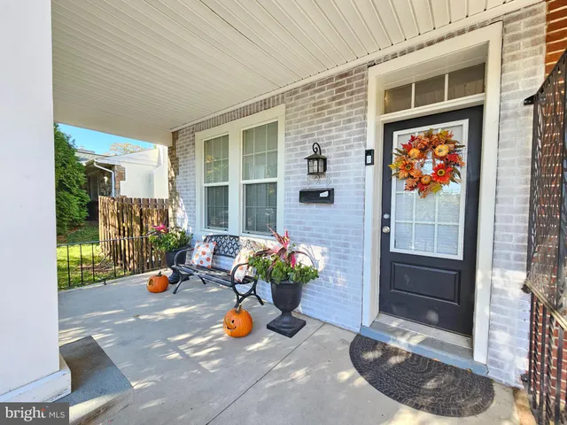 a view of a entryway door of the house with outdoor seating