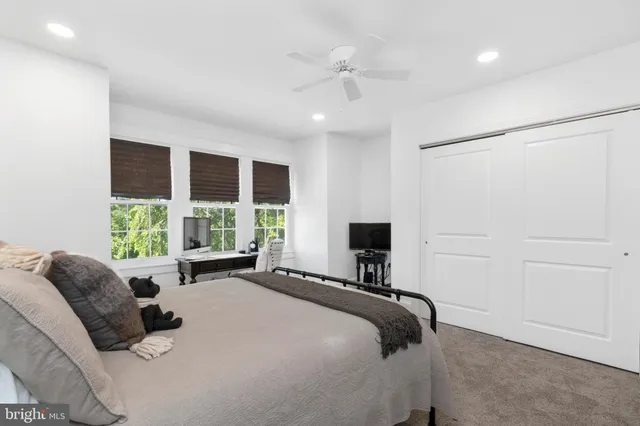 a bed room with a bed and a television