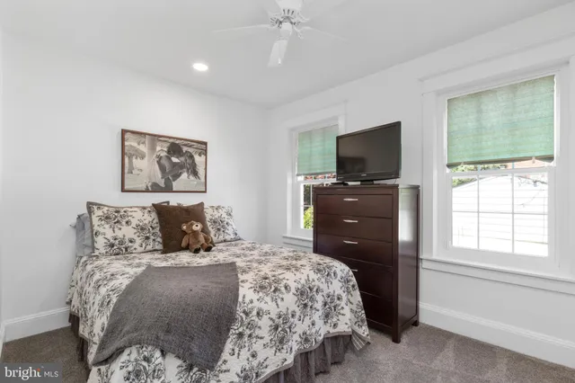 a bedroom with a bed and a television