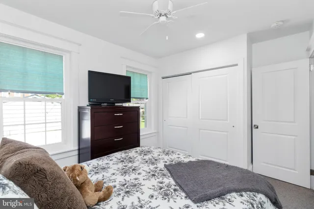 a bedroom with a bed and a television