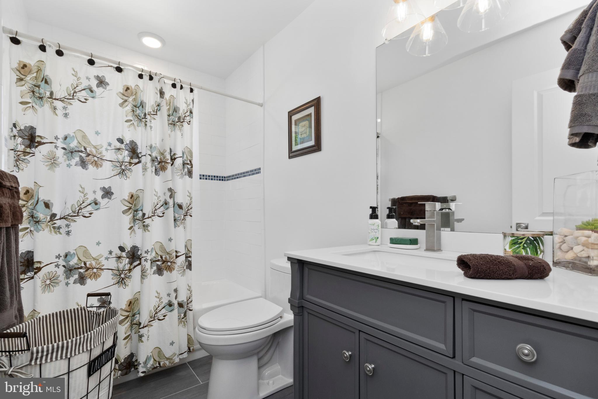 528 Lower E Valley Forge Road King of Prussia, PA 19406 - Photo 26 of 40 a bathroom with a sink a toilet and shower curtain