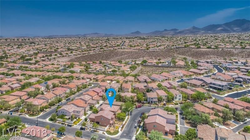3144 Whitfeild Avenue Henderson, NV 89044 - Photo 39 of 55 An aerial perspective reveals a vast community nestled against a mountainous backdrop.