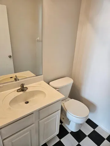 a bathroom with a sink a toilet and a mirror