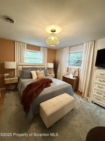 a bedroom with bed and window