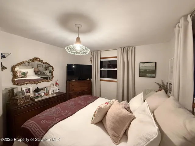 a bedroom with a bed and dresser