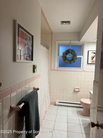 a view of a hallway with paintings on the wall