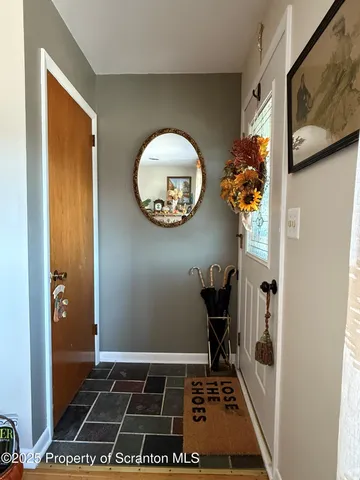 a view of a hallway with wooden floor and workspace