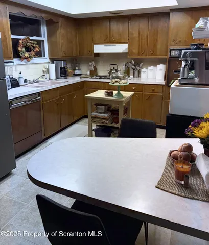 a kitchen with a sink cabinets and appliances