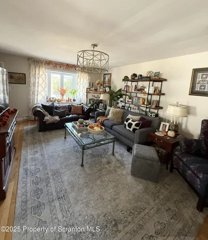a living room with furniture and a dining table