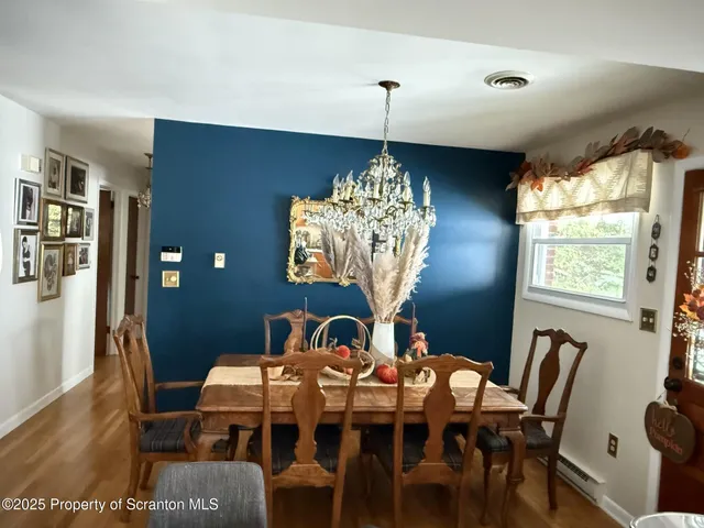 a view of a dining room with furniture and chandelier