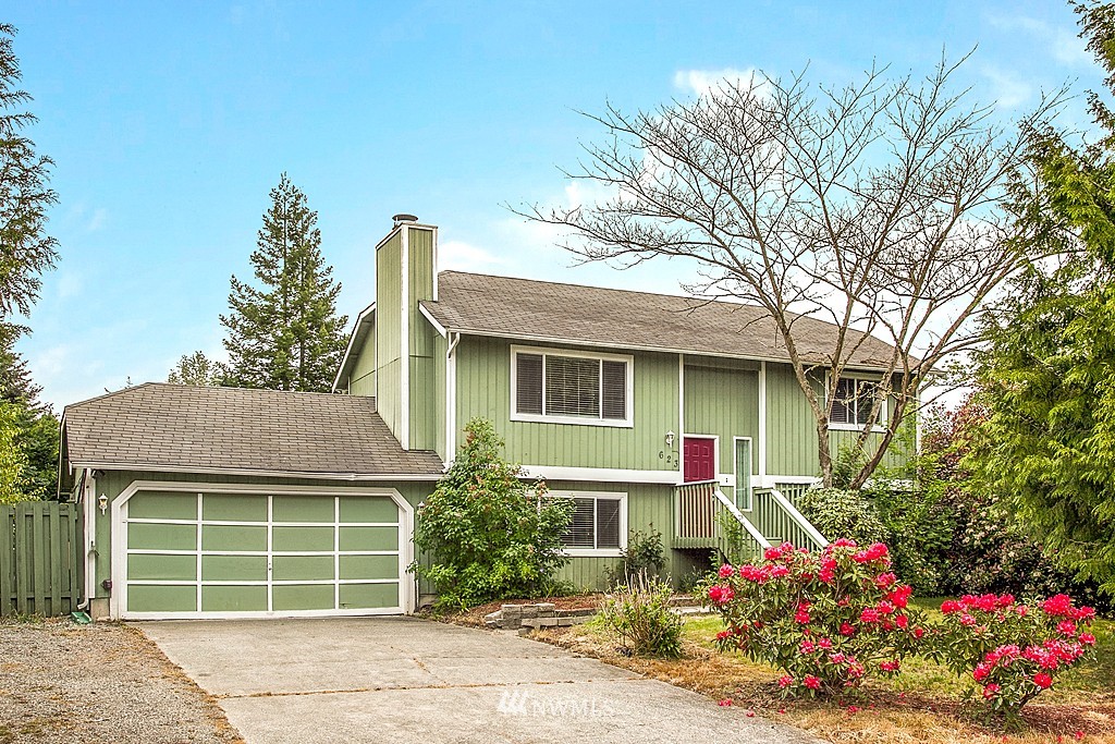 623 Harvest Road Bothell, WA 98012 - Photo 1 of 11 a front view of a house with a yard and garage