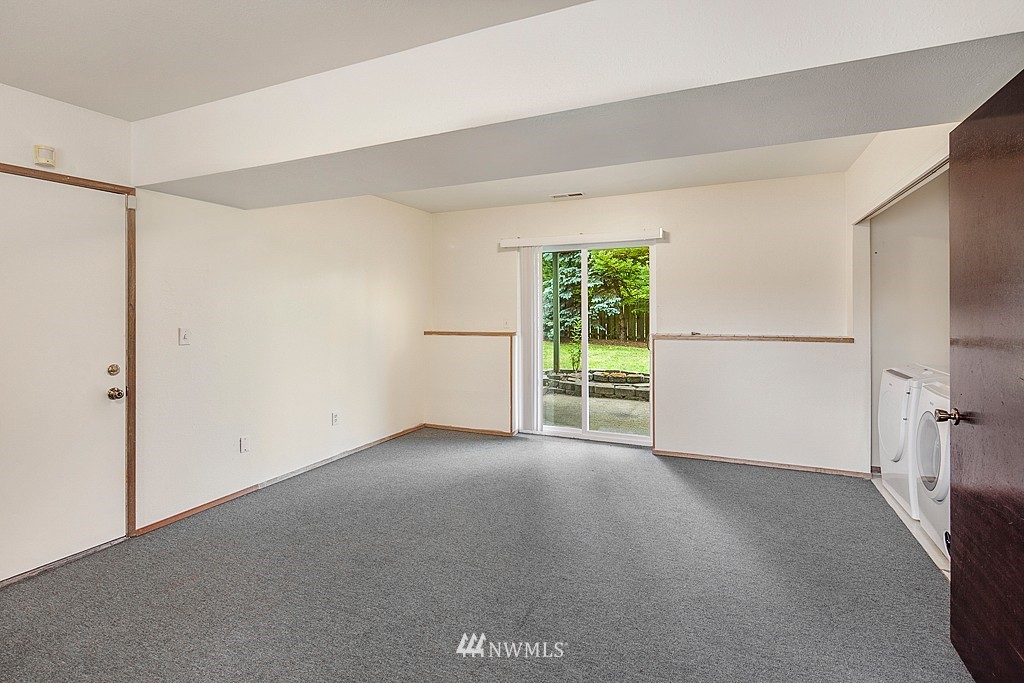 623 Harvest Road Bothell, WA 98012 - Photo 7 of 11 a view of a room with an empty space and a window