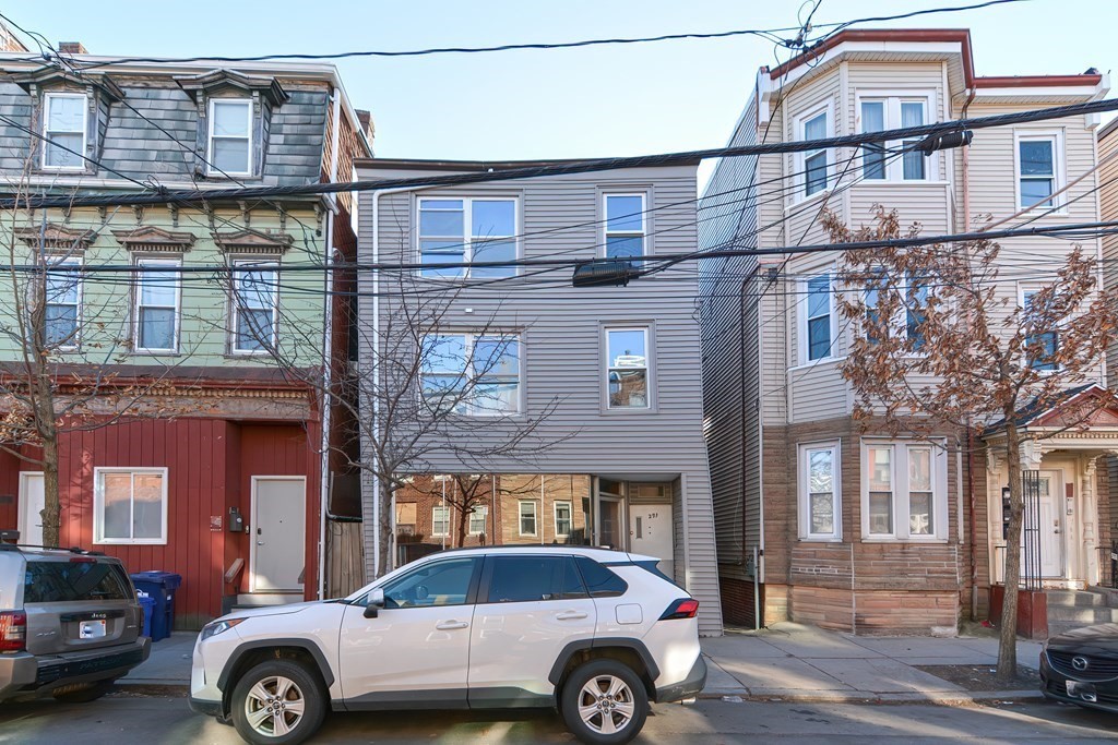 291 Sumner Street Boston, MA 02128 - Photo 1 of 41 a front view of a house with parking space