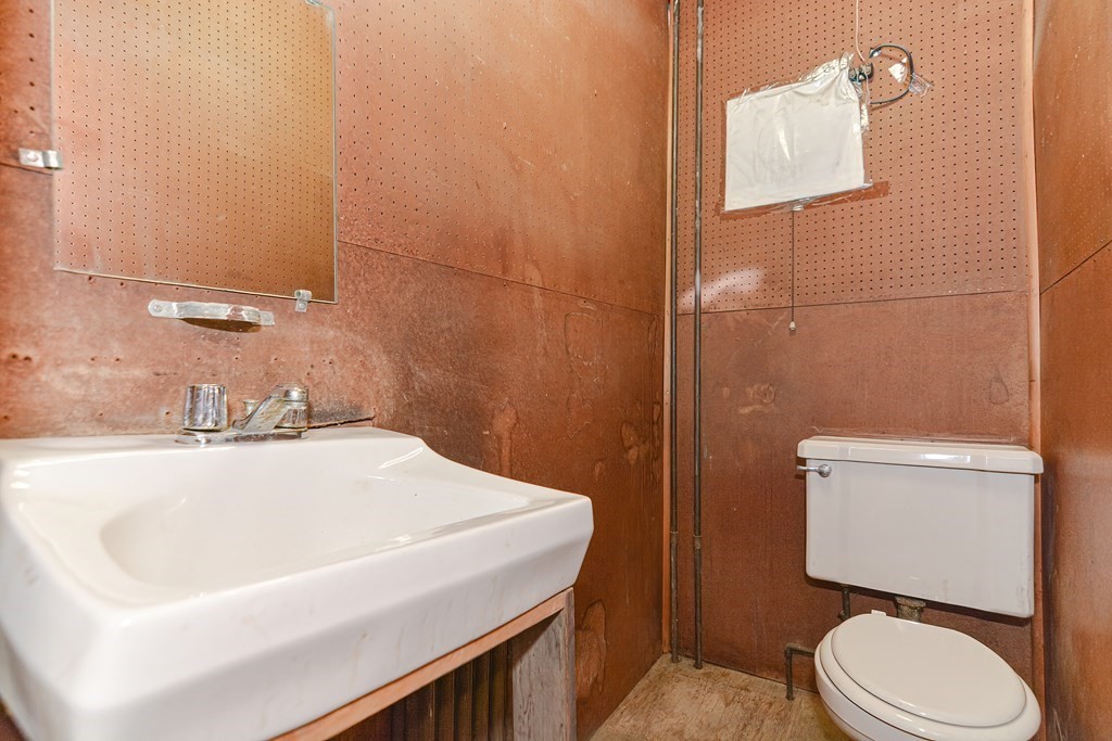 291 Sumner Street Boston, MA 02128 - Photo 12 of 41 a bathroom with a sink a toilet and mirror