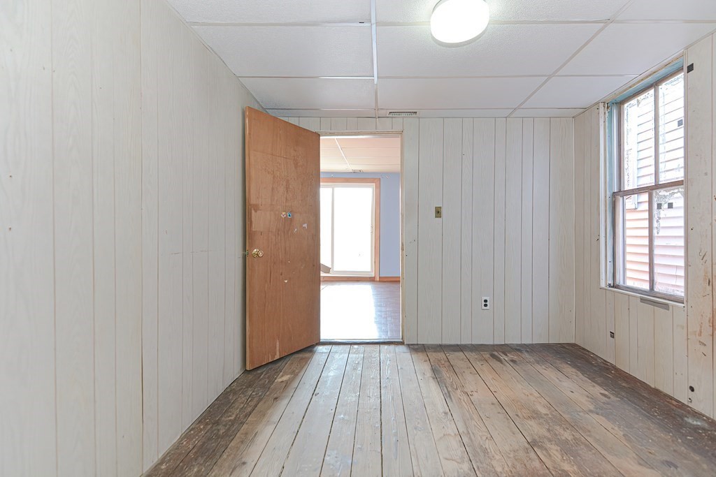 291 Sumner Street Boston, MA 02128 - Photo 27 of 41 a view of a room with wooden floor and windows