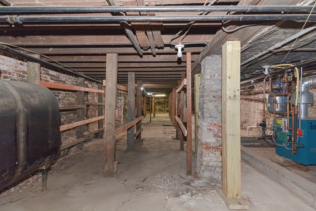 291 Sumner Street Boston, MA 02128 - Photo 39 of 41 a view of water heater room with wooden wall