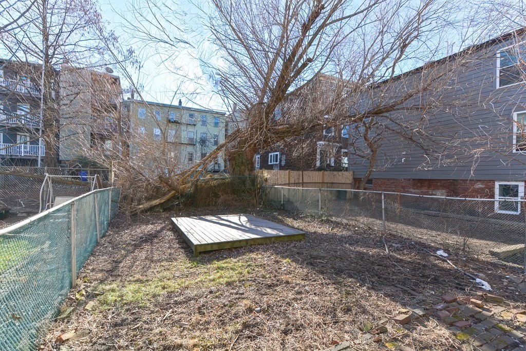 291 Sumner Street Boston, MA 02128 - Photo 5 of 41 a view of a yard with trees
