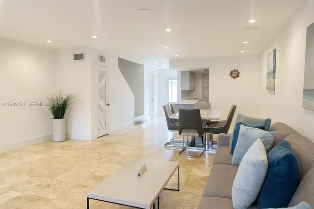 a living room with furniture and white walls