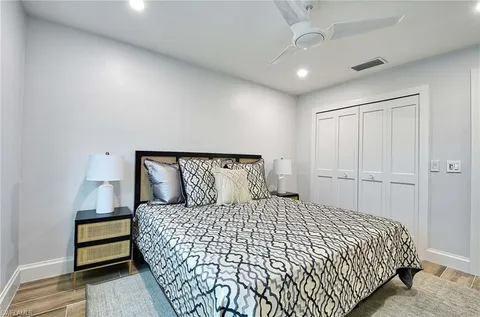 a bedroom with a large bed and a chandelier