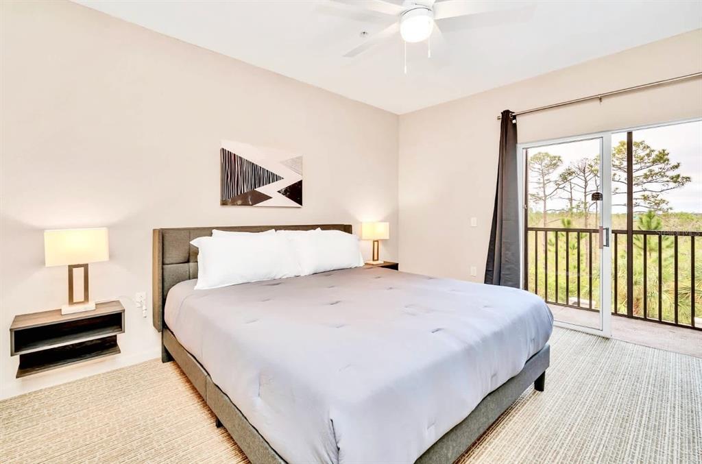 14200 Avalon Road, Unit 426 Winter Garden, FL 34787 - Photo 11 of 44 a bedroom with a large bed and a window