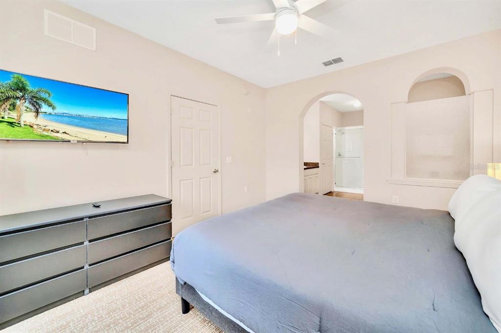 14200 Avalon Road, Unit 426 Winter Garden, FL 34787 - Photo 12 of 44 a bedroom with a bed and a chandelier