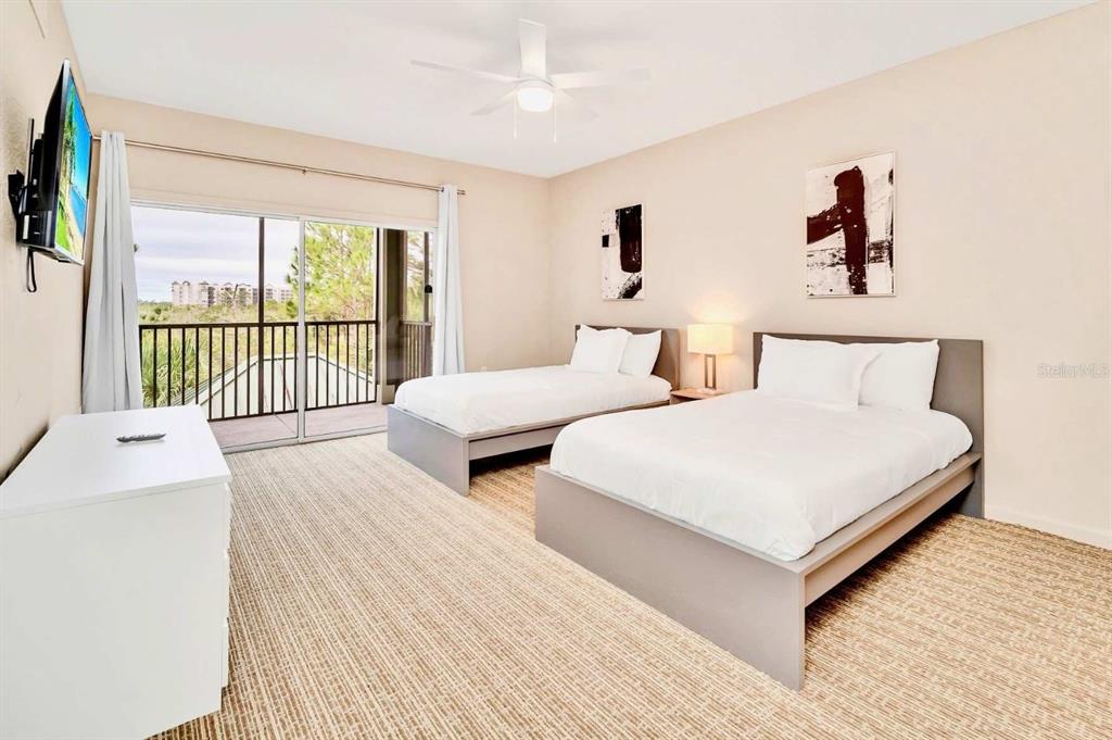 14200 Avalon Road, Unit 426 Winter Garden, FL 34787 - Photo 15 of 44 a bedroom with two beds and a large window