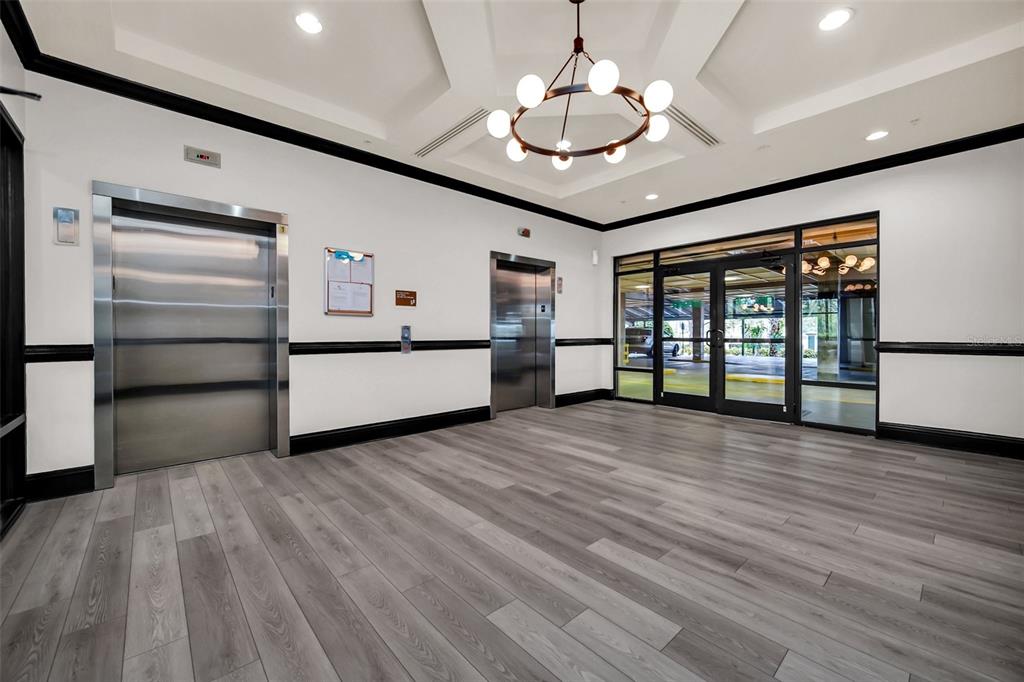 14200 Avalon Road, Unit 426 Winter Garden, FL 34787 - Photo 23 of 44 a view of a electric appliances in kitchen and empty room with wooden floor