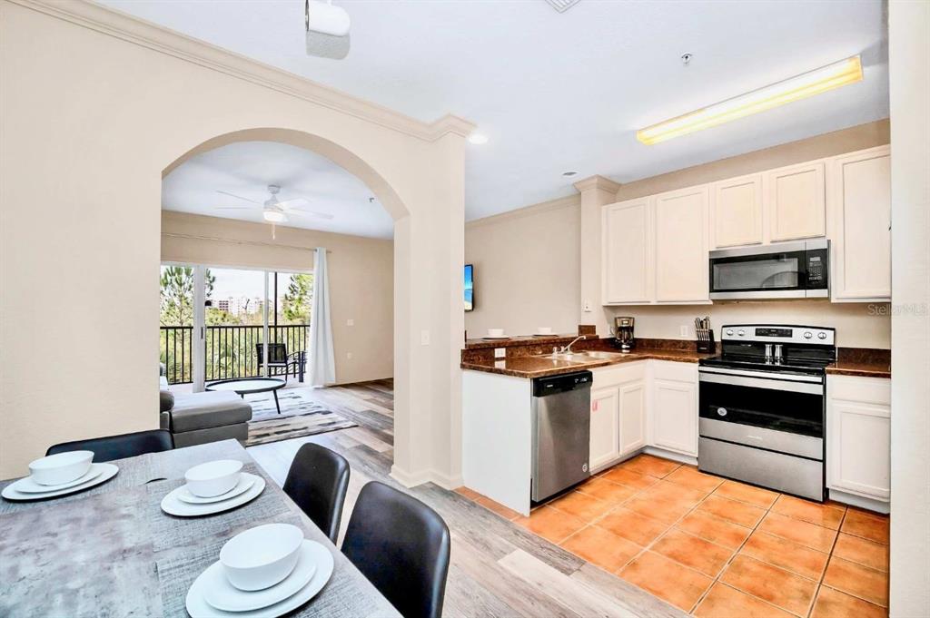 14200 Avalon Road, Unit 426 Winter Garden, FL 34787 - Photo 3 of 44 a kitchen with stainless steel appliances kitchen island granite countertop a sink and cabinets