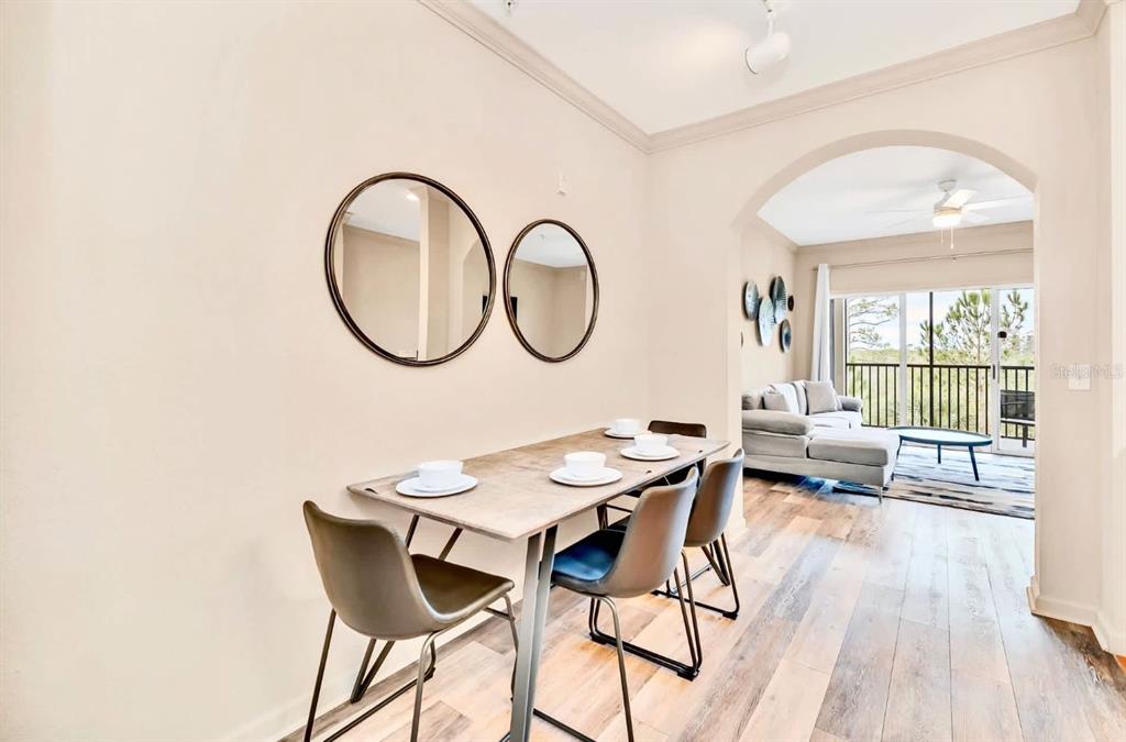 14200 Avalon Road, Unit 426 Winter Garden, FL 34787 - Photo 6 of 44 a dining room with furniture and wooden floor