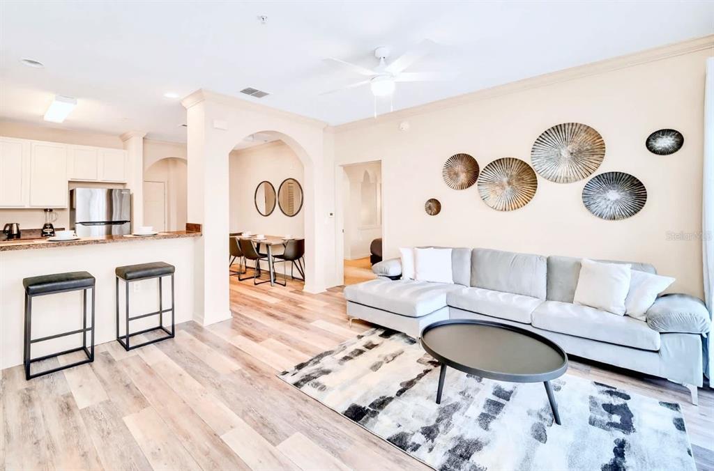 14200 Avalon Road, Unit 426 Winter Garden, FL 34787 - Photo 7 of 44 a living room with furniture and a wooden floor