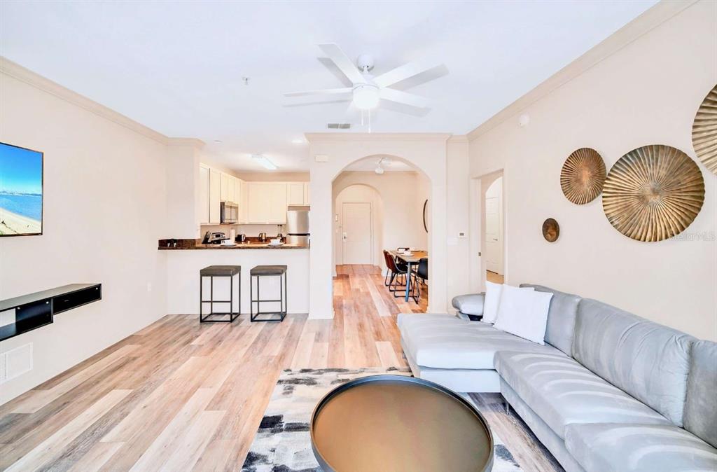 14200 Avalon Road, Unit 426 Winter Garden, FL 34787 - Photo 8 of 44 a living room with furniture and a wooden floor