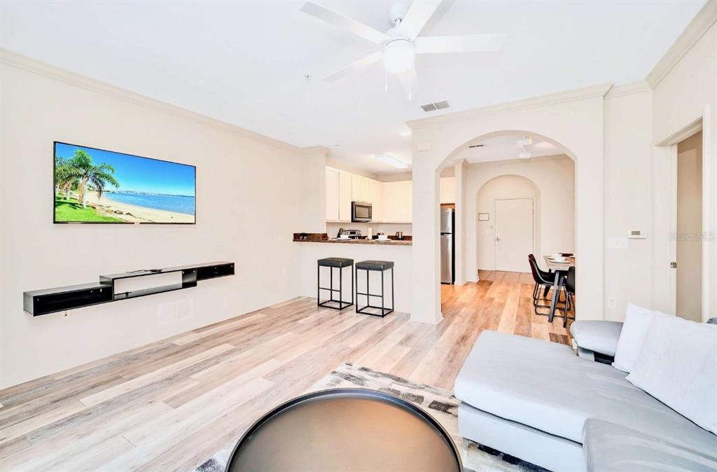 14200 Avalon Road, Unit 426 Winter Garden, FL 34787 - Photo 9 of 44 a living room with furniture and a flat screen tv