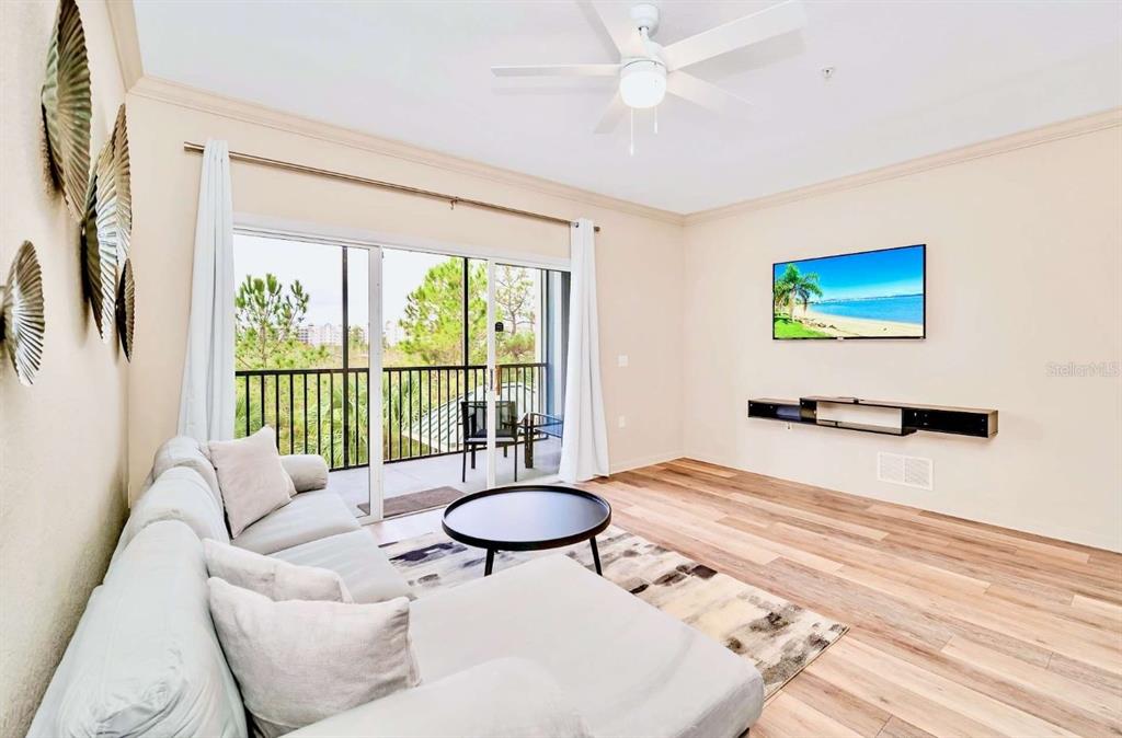 14200 Avalon Road, Unit 426 Winter Garden, FL 34787 - Photo 10 of 44 a living room with furniture and a large window
