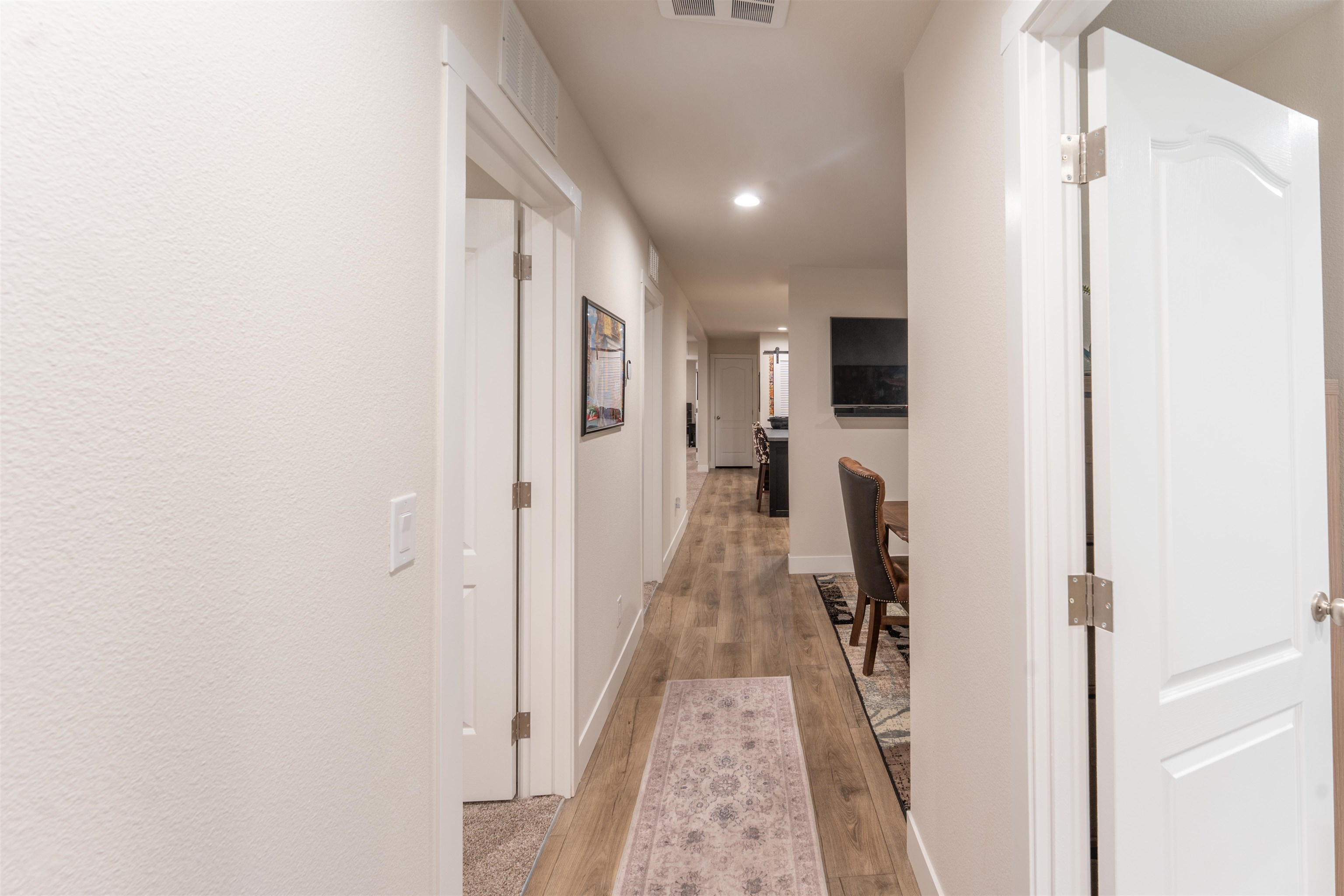 264 Holly Berry Way Fruita, CO 81521 - Photo 17 of 27 a hallway with a view of living room with wooden floor